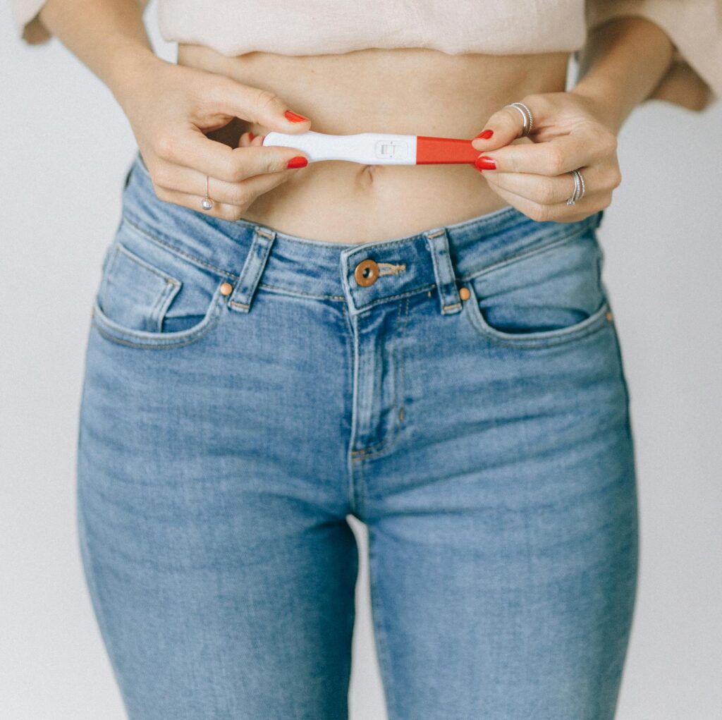 pregnant, Close-up of a woman holding a positive pregnancy test, depicting a moment of happiness.