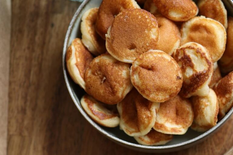 A flat lay showcasing baby pancakes on a wooden table.