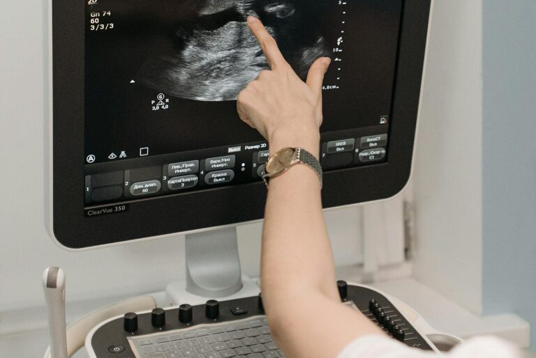 A medical professional analyzing an ultrasound image on a monitor in a clinical setting. gender disappointment