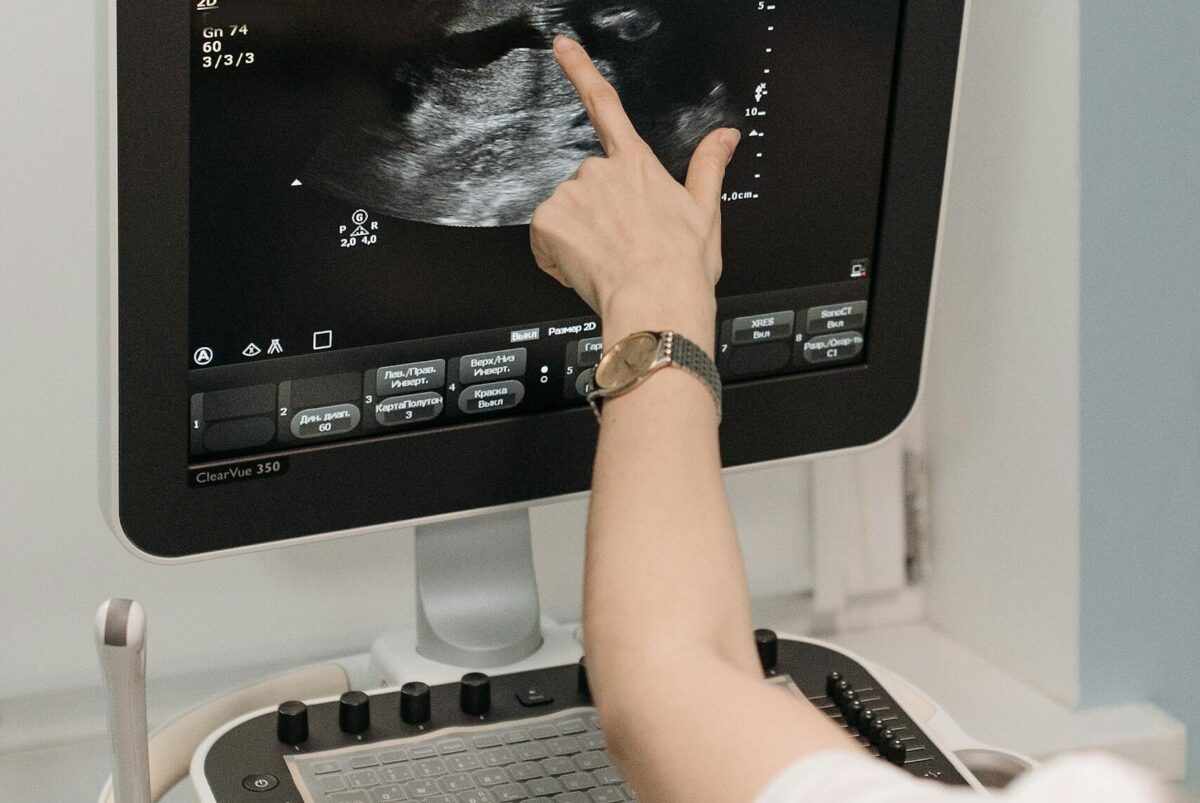 A medical professional analyzing an ultrasound image on a monitor in a clinical setting. gender disappointment