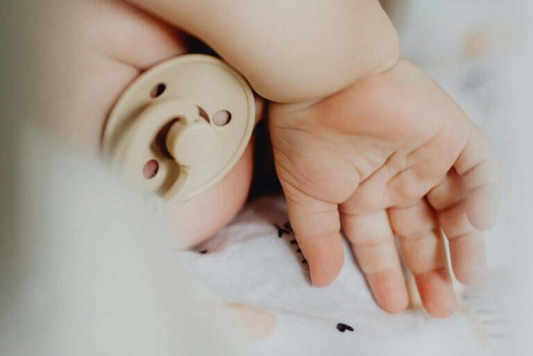 ditch the pacifier: A serene close-up of a sleeping baby with a pacifier, showcasing tenderness and tranquility.